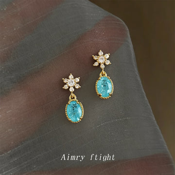 Gold Tone Clear Stone Snowflake And Aqua Oval Stud Earrings