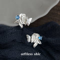 Silver Tone Sculpted Rose Butterfly And Blue Stone Stud Earrings view 1