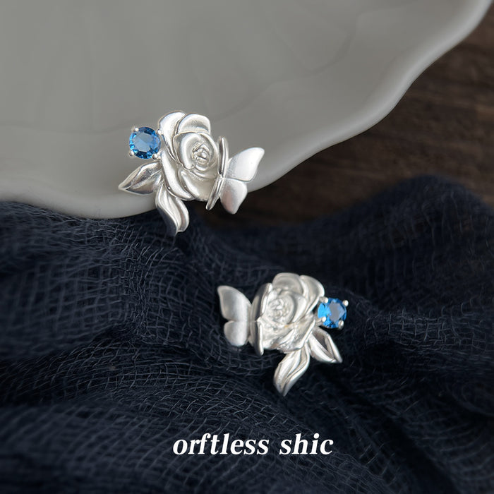 Silver Tone Sculpted Rose Butterfly And Blue Stone Stud Earrings