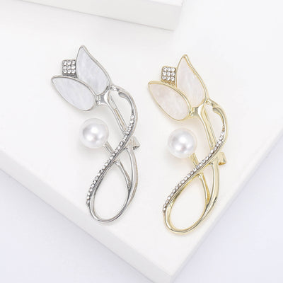 Front view of the tulip pearl brooch in silver and gold tone finishes brooch and its color options