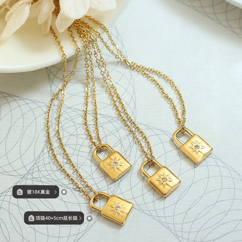 Four gold padlock pendants flat lay with plating and length labels