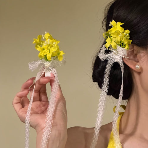 Yellow flower lace ribbon hair clip held and worn in side bun