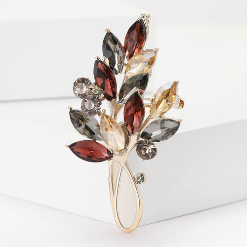 Close-up product view showing the colors and surface details of the two leaf crystal branch brooch