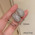 Oval Pave Scrollwork Clip-On Earrings In Gold And Silver Tones view 4