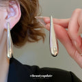 Sculptural Long Teardrop Stud Earrings in Silver and Gold Tones view 3