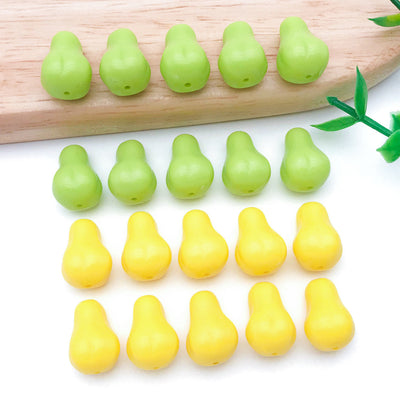 Yellow and green pear shaped acrylic beads arranged as a full product overview
