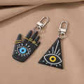 Silver Tone Black Triangle and Hamsa Eye Clip Keychains view 1