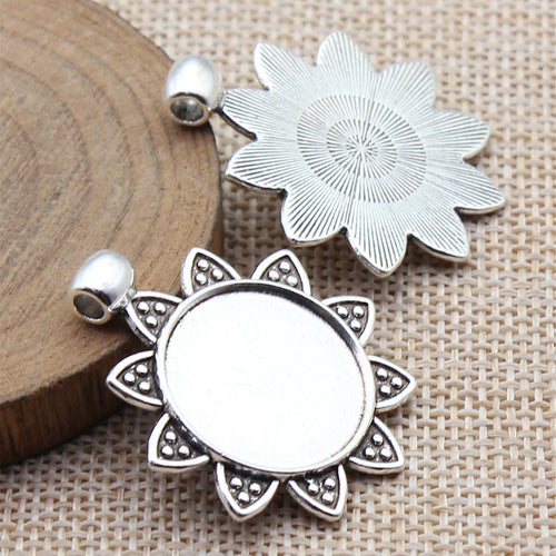 Two Finish Sunflower Round Pendant Setting displayed on a natural textured background