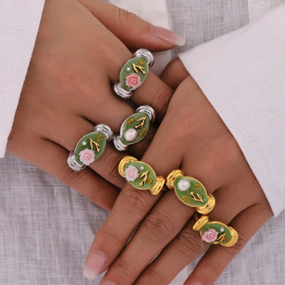 Steel and gold green enamel floral open rings on model hands