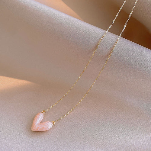styled close view of pastel heart pendant necklaces