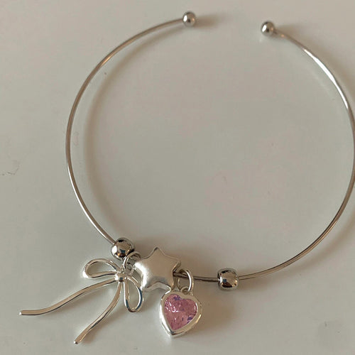 Silver open cuff bracelet with bow star and pink heart charms