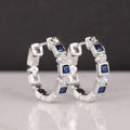 Silver Tone Hoop Earrings With Alternating Blue and Clear Stones view 3