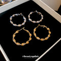 Gold Tone Twisted Hoop Earrings With Leaf Shaped Links view 2