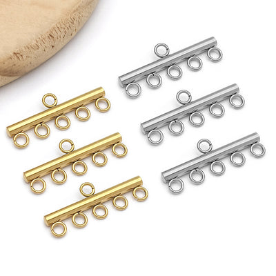 Gold-tone connector clasp jewelry findings arranged on a light background