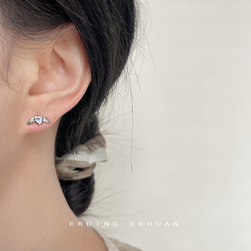 Silver heart angel wing stud worn on ear side profile