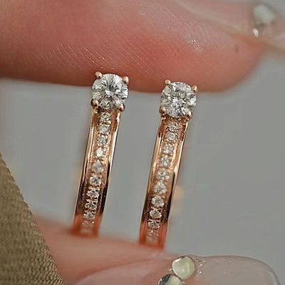 Product view showing rose-gold-tone hoops with one clear row and one pale pink stone row