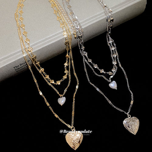 layered heart pendant necklace displayed in a styled close view