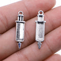Short Syringe Double-Sided Metal Charm in Two Antique Finishes view 1