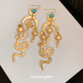 Gold Tone Sun Moon and Snake Dangle Earrings With Polished Metal Details view 4