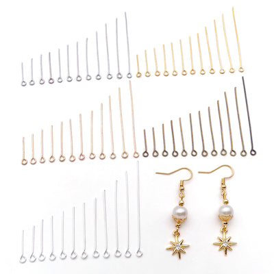 Metallic eye pin jewelry findings arranged on a light background