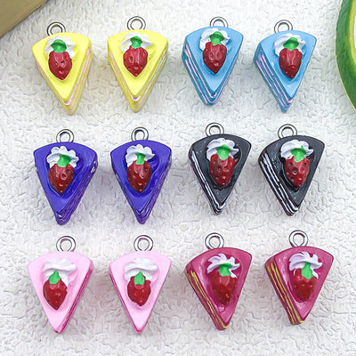 Multicolor strawberry and cake charms arranged on a light background