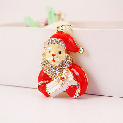 Front view of a red Santa charm holding a white wrapped present.