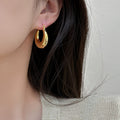 Rounded Chunky Hoop Earrings with Smooth Gold Tone Finish view 4