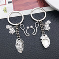 Two Silver Tone Ambulance Syringe and Heart Keychains view 2