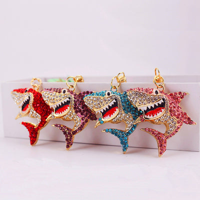 Four rhinestone shark charms shown together in red, purple, blue, and pink.