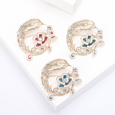 Feather And Flower Wreath Brooch on white background