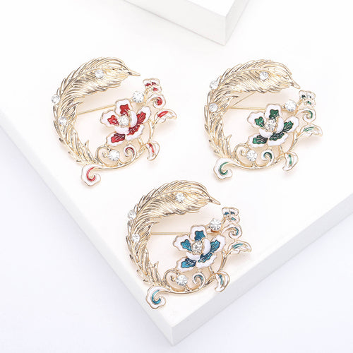 Feather And Flower Wreath Brooch on white background