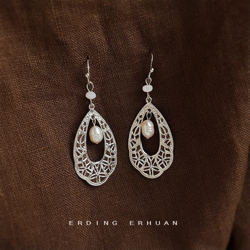 Silver-tone openwork-teardrop white-pearl hook earrings in the first product display.