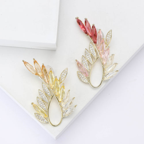 Pink and yellow olive branch rhinestone brooches on white blocks