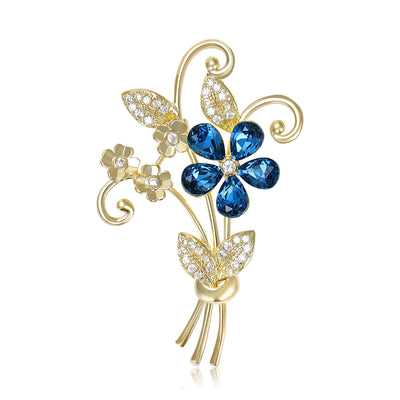 Front view of elegant blue crystal flower bouquet brooch in gold tone