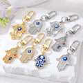 Gold and Silver Tone Crystal Hamsa Hand Evil Eye Clip Keychains in Ten Designs view 1
