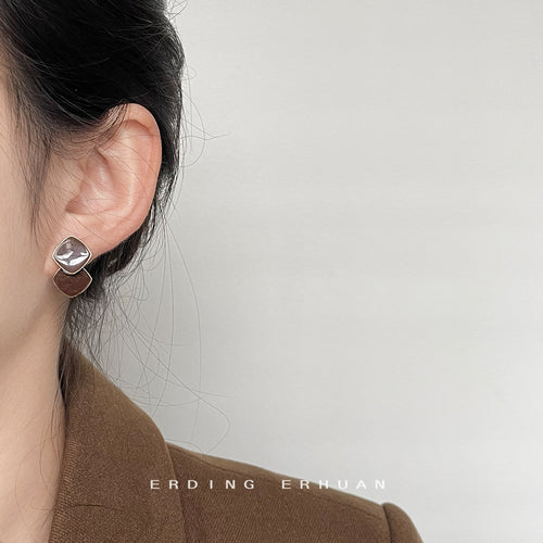 Brown stacked enamel stud worn on ear side view