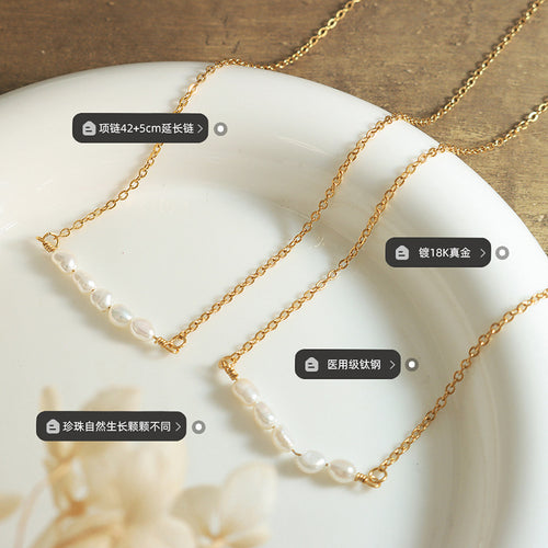 Close flat lay of gold pearl bar necklace with length material labels