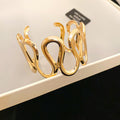 Spiral Disk And Organic Loop Open Cuffs In Gold Or Silver Tone view 7