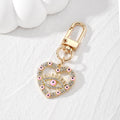 Gold Tone Rhinestone Heart Lash Eye Clip Keychains in Five Colors view 2