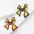 Antique Gold Enamel Bow Brooch Black or Red Outline Pin view 1
