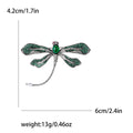 Green Dragonfly Metal Brooch with Dark Green Wings, a Pink Center Stone, and Curved Tail view 4
