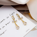 Gold Huggie Bow and Clear Look Open Teardrop Drop Earrings view 4