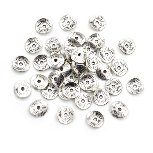 Curved Rolled Edge Round Spacer Discs in Antique Silver assortment on a plain background