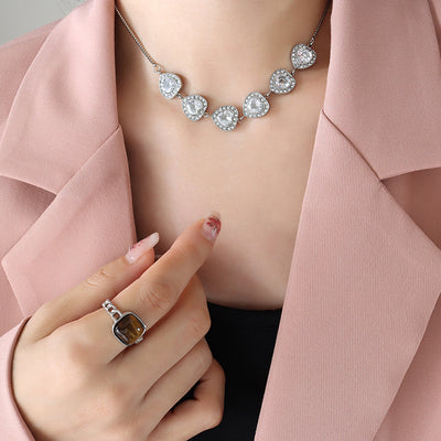 Model in pink blazer wearing clear heart halo zirconia necklace