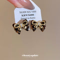 Gold Tone Bow Stud Earrings With Black Enamel Accents view 2