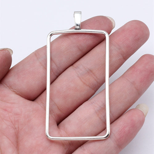 Large Rectangle Open Frame Pendant in Silver Tone Metal shown in image 1, highlighting a large open rectangle, slender m