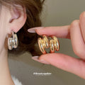 Crossed Triple Hoop Earrings in Gold and Silver Tone view 2