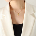 Gold Hand Holding Green Zircon Pendant Ball Chain Necklace view 3