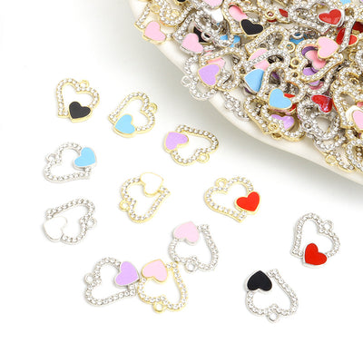 Assorted open heart charms arranged on a white background