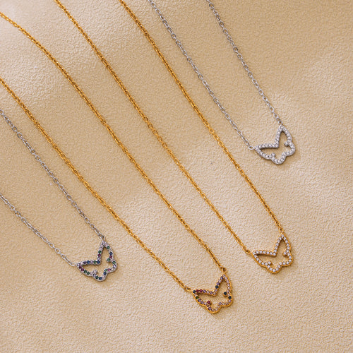 Four butterfly zircon necklaces gold and steel on fabric